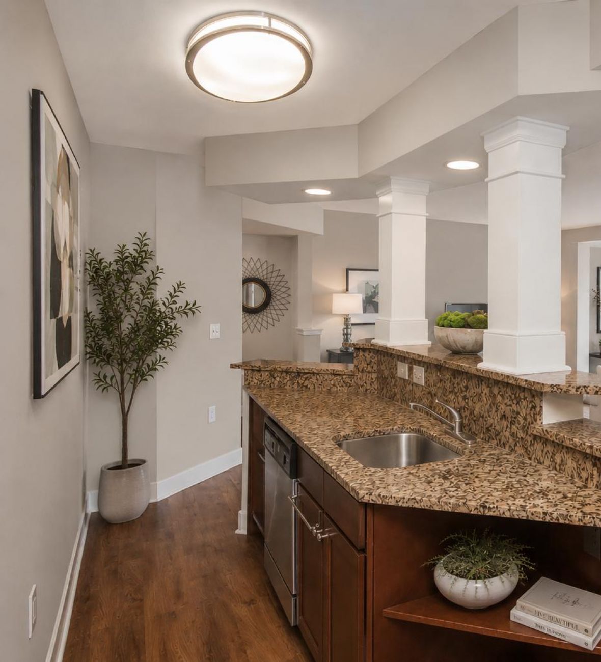 The Encore apartment homes with Modern open-concept living room and kitchen with granite countertops and neutral-toned decor.